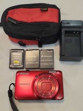 Nikon red COOLPIX compact camera with charger, batteries and red/black case